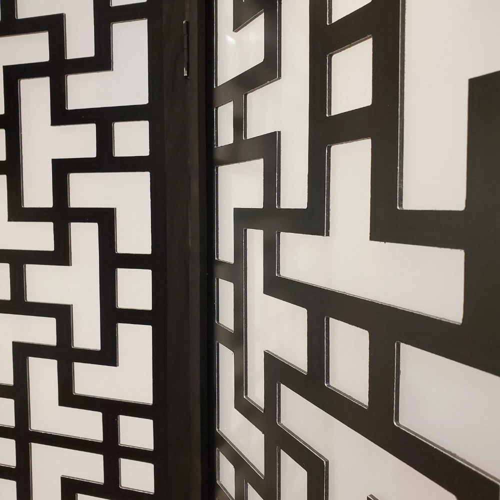 Close-up of decorative black and white geometric patterned doors.